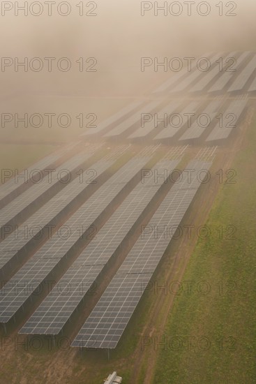 Landscape with solar panels in fog, atmospherically dense and sustainable, energy transition, construction of PV open space, Baden-Württemberg, Germany