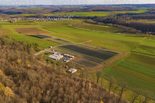 Panorama of a landscape with solar plant, forests and village in an autumn environment, energy revolution, construction of PV open space, Baden-Württemberg, Germany