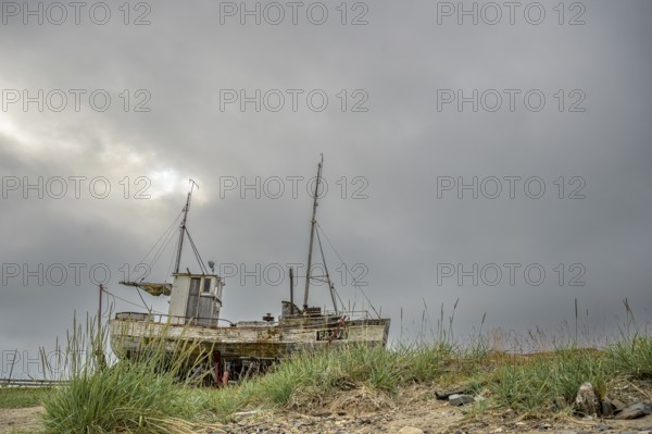 An old fishing boat on the beach of the Varangerfjord, Vestre Jacobselv, Finnmark, Norway