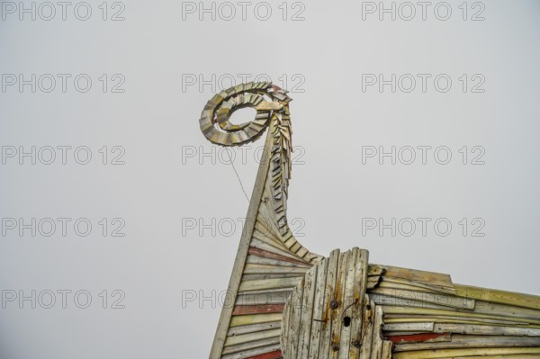 Close-up of an artfully designed wooden Viking dragon head, sculpture by Drakkar Vardø. The Drakkar-Leviathan sculpture was built in summer 2016 by the Taibola Assemble team from Archangelsk Severodvinsk, Vardø, Finnmark, Norway