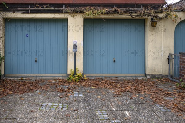Parking meter between two garages, Bavaria, Germany