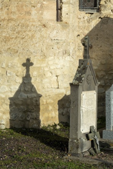 Mazerier village. A weathered tombstone is shown in the daylight. It is near church of St Saturninus. Allier department in Auvergne Rhone Alpes, France. Europe