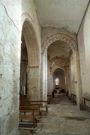 St Cyr and St Julitte's Church, roman church of Escurolles. North aisle with quarter-circle vault and pointed arches. Allier department, Auvergne Rhone Alpes, France