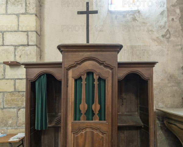 Ancient wooden confessional in a Roman Catholic church. France. Europe