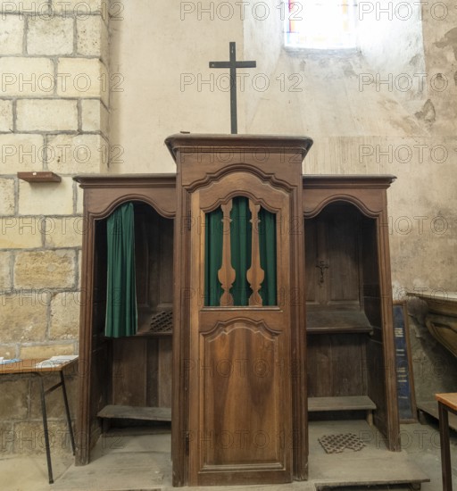Ancient wooden confessional in a Roman Catholic church. France. Europe