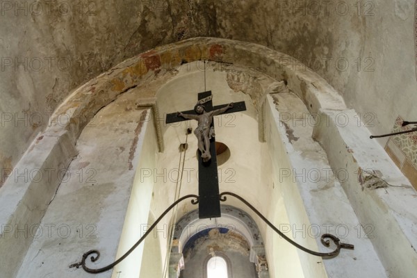 Maerier village. Low angle shows the architecture and crucifix hanging within the St Saturninus Church, Allier, Auvergne Rhone Alpes, France. Europe