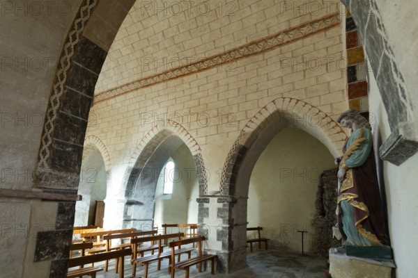 Painted church St Aignan's Church of Begues. Ogival arcades. Allier department. Auvergne Rhone Alpes. France. Europe