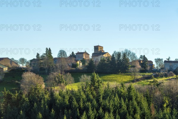 Issoire. Pillar (The Annunciation made to Mary) . The figures are illuminated by colorful light shining through a stained glass window inside Saint Austremoine Abbey, Puy de Dome, Auvergne Rhone Alpes, France