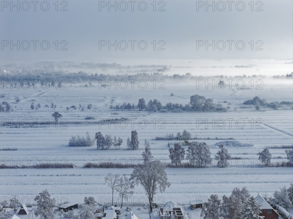 The onset of winter with snow and ground fog in Hamburg's Kirchwerder Wiesen Nature Reserve in the Vier- and Marschlanden. aerial view. Kirchwerder, Hamburg, Germany