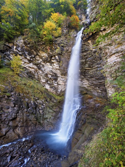 Diesbach waterfall in autumn-colored surroundings, Linthal, Klausenpass, Canton of Glarus, Switzerland