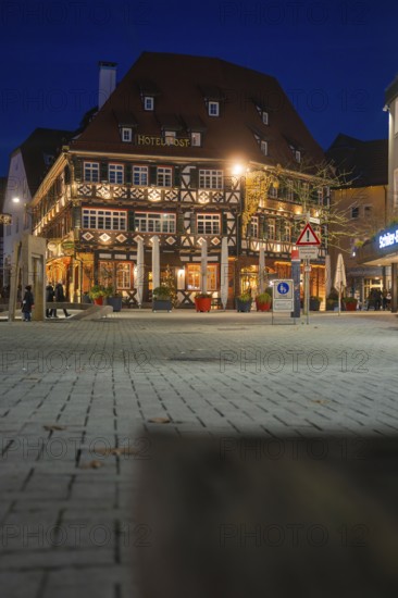 Traditional half-timbered hotel at night with lighting on an urban square, Nagold, Calw district, Black Forest, Germany