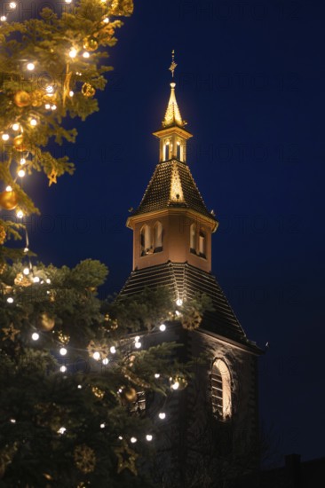 Close-up of church tower with Christmas tree and lights at night, Nagold, Calw district, Black Forest, Germany