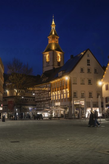 Church tower and half-timbered houses stylishly illuminated at night on a town square, Nagold, Calw district, Black Forest, Germany