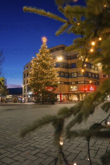 Christmas tree at night, festively lit, in front of a commercial building, Nagold, Calw district, Black Forest, Germany