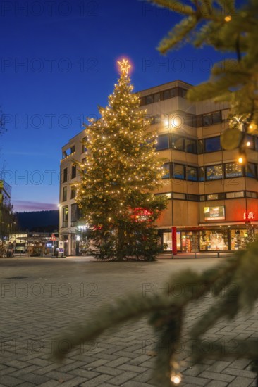 Christmas tree with lights in front of a building in an urban area at night, Nagold, Calw district, Black Forest, Germany