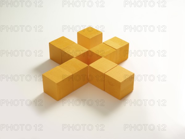 9 yellow wooden cubes against a white background
