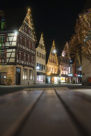 Illuminated half-timbered houses line the Old Town Street at night and create a festive atmosphere, Nagold, Calw District, Black Forest, Germany