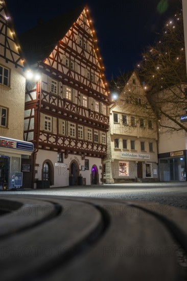 Charming half-timbered houses in an old town, softly lit by fairy lights at night, Nagold, Calw district, Black Forest, Germany