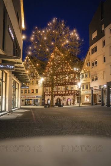 Festively illuminated old town with a large light tree in the evening light, Nagold, Calw district, Black Forest, Germany