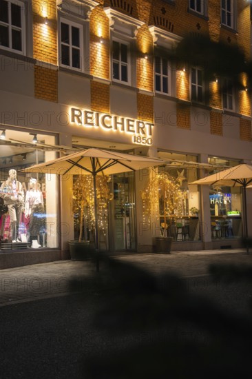Illuminated shop windows of a clothing store with festive decoration, Nagold, Calw district, Black Forest, Germany
