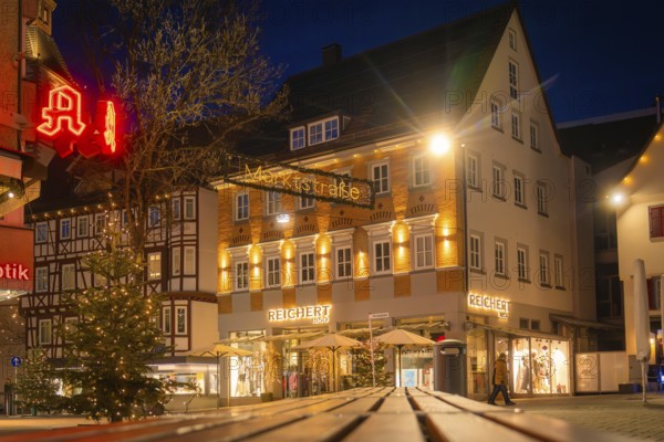 Historic street with illuminated shops and Christmas decorations in the evening mood, Nagold, Calw district, Black Forest, Germany