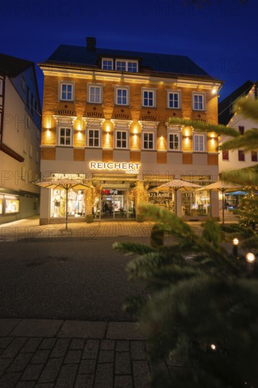 Festively illuminated building in the urban evening atmosphere, Nagold, Calw district, Black Forest, Germany