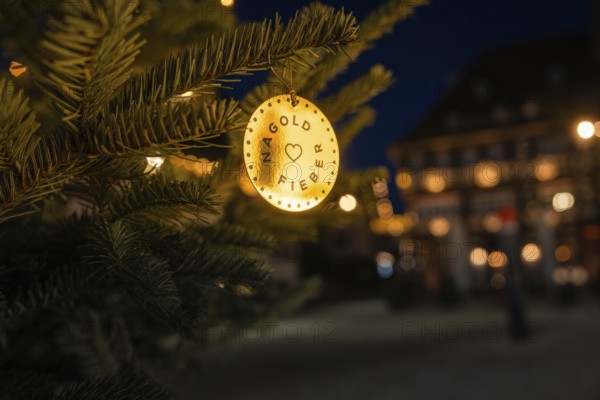 A festively decorated Christmas tree at night with warm lights and blurred background, Nagold, Calw district, Black Forest, Germany