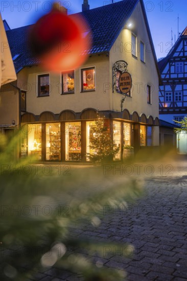 Commercial building with Christmas decoration and half-timbering at dusk, Nagold, Calw district, Black Forest, Germany