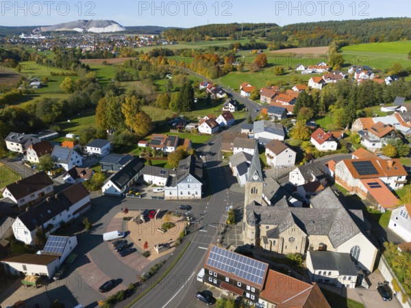 Wide view of a village with church, nestled in an autumn landscape, aerial view, Niederkalbach, Kalbach municipality, Fulda district, Hessian Rhön nature park Park, Hesse, Germany
