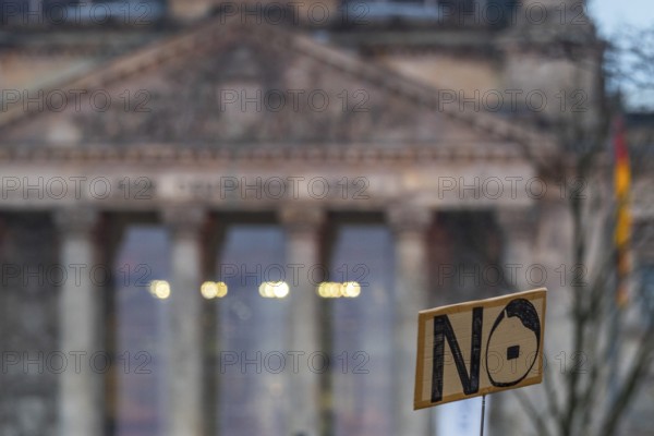 Sign with the inscription No, No, and stylized head of Adolf Hitler, in the back the German Bundestag in the Reichstag, demonstration against right-wing radicalism and fascism on February 2, 2025, Platz der Republik, Berlin, Germany