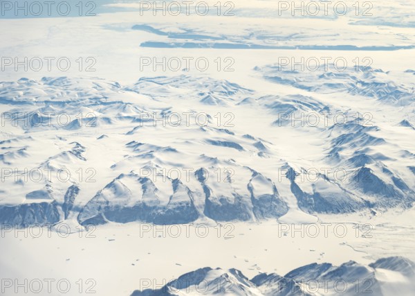 Glacier tongues flow into huge glaciers, snowy arctic mountain landscape, aerial view, Greenland, Arctic