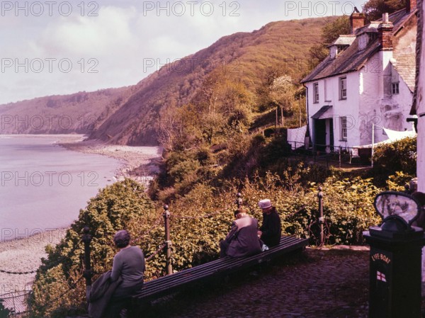 View of coastline with wooden cliffs from the harbour at Clovelly, north Devon, England, UK 1960s