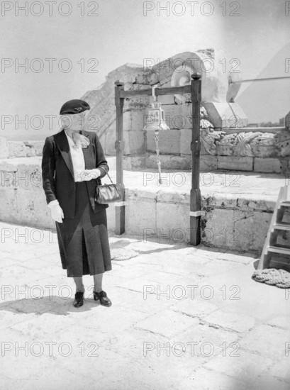 British woman, presumably a Royal Navy officer's wife, standing by ships bell of HMS Phoenicia shore station, Manoel Island, Malta, Europe, 1957