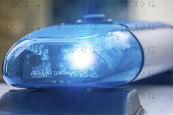 Symbolic image police operation: close-up of a blue light on a police car (digitally reworked)