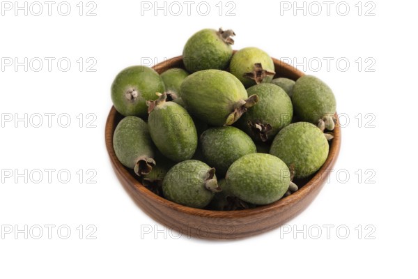 Ripe Feijoa in wooden bowl isolated on white background, side view, close up, minimalism