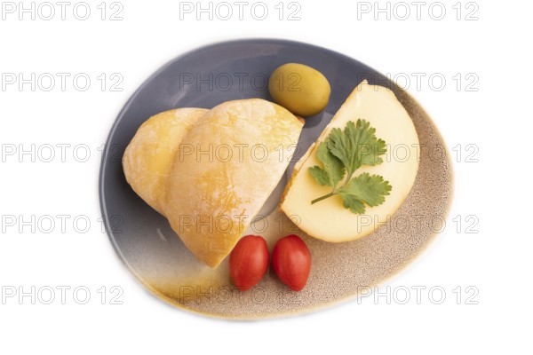 Smoked Mozzarella cheese, with tomatoes and olives isolated on white background, top view, flat lay, copy space