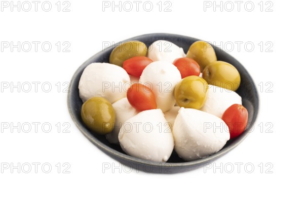 White Mozzarella cheese, with tomatoes and olives in blue bowl Isolated on white background, side view, close up