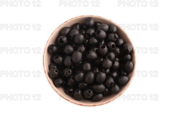 Fresh black olives in ceramic bowl Isolated on white background. Top view, flat lay, close up