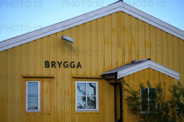 Yellow wooden building with simple, clear architecture, A yellow wooden building with two windows and Scandinavian design, Nordfjord, Båtsfjord, Finnmark, Norway