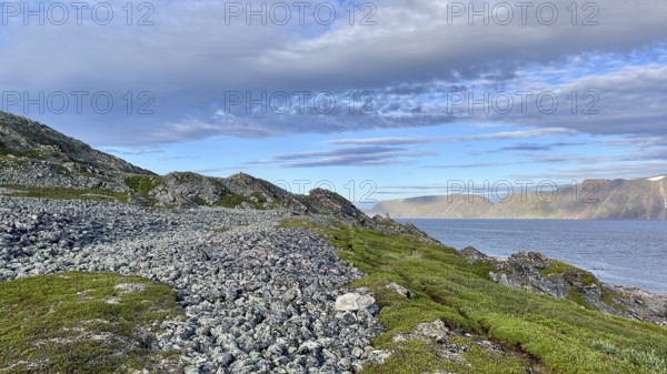 Rocky coastal landscape with sea views and a peaceful atmosphere in cloudy skies on Syltejjord on the Varanger Peninsula in northern Norway, Ytre Syltefjord, Finnmark, Norway