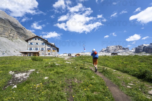 Hikers in front of Rifugio Graffer, Brenta, Brenta-Adamello Natural Park, Trentino, Italy