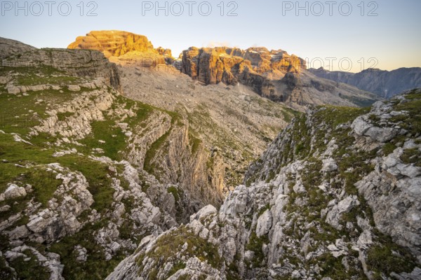 View of rocky mountain peaks of the Brenta Mountains at sunset, Alpenglühen, mountain landscape on the Grosté Plateau, Brenta, Parco Naturale Brenta-Adamello, Trentino, Italy