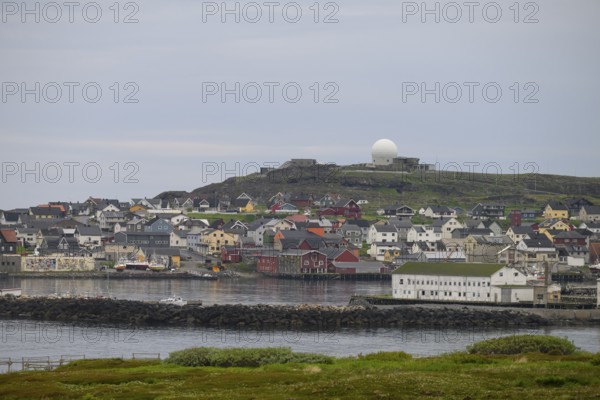 View of the port city of Vardø with large NATO radar systems on a hill in the background, Vardö, Finnmark, Norway