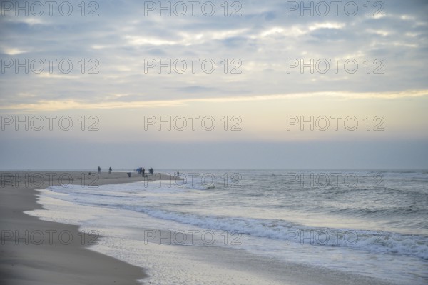 People stroll along the beach in a calm evening mood, Texel island, Noord Holland, the Netherlands
