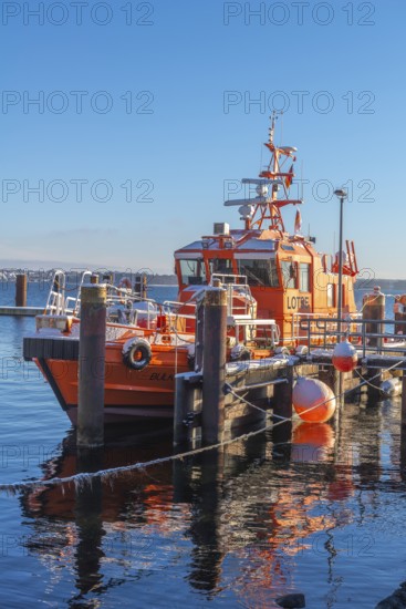 Kiel-Holtenau pilot station in front of the Kiel Canal, pilot boat, channel guidance, shipping, safety, dolphins, pier, Kiel Fjord, Baltic Sea, on the horizon the east bank, calm sea, winter, snowfall, sunshine, blue sky, Kiel, Germany
