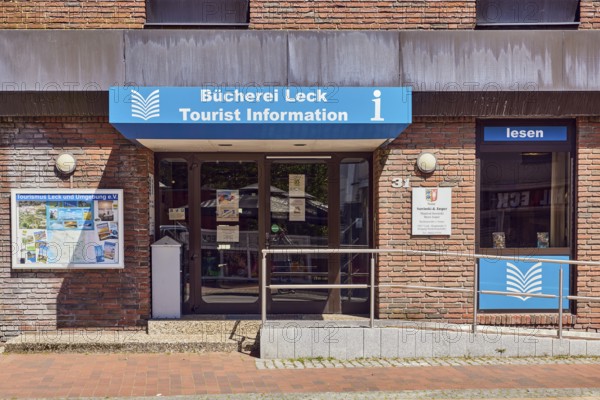 Tourist information, library leak, public library, commercial building, brick building, entrance with door and ramp, stainless steel railing, shop window, showcase, sunny, main street, leak, district of North Frisia, Schleswig-Holstein, Germany