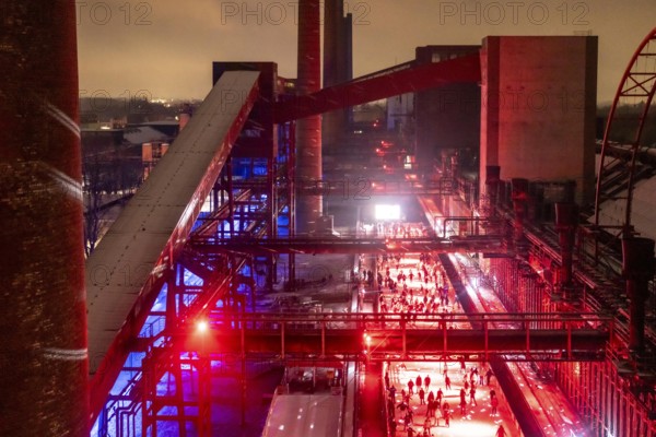 Ice rink at the Zollverein coking plant, ice skating with music and many lighting effects, Essen, North Rhine-Westphalia, Germany