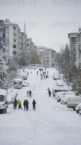 In Gaziantep, Turkey, on December 31, 2025, children and families enjoy winter activities as they play on snow-covered areas and slide on icy hills, creating a lively atmosphere across the city during the final day of the year, Gaziantep, Gaziantep, Turkey