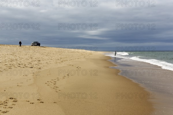 Ocean walkers, fall cloud cover, SUV on horizon, offroad, Provincetown, Race Point Beach, Cape Cod National Seashore, Atlantic Coast, Massachusetts, New England, USA