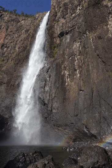 Daytime view from below of Wallaman Falls cascading into a rainforest gorge, Queensland, Australia